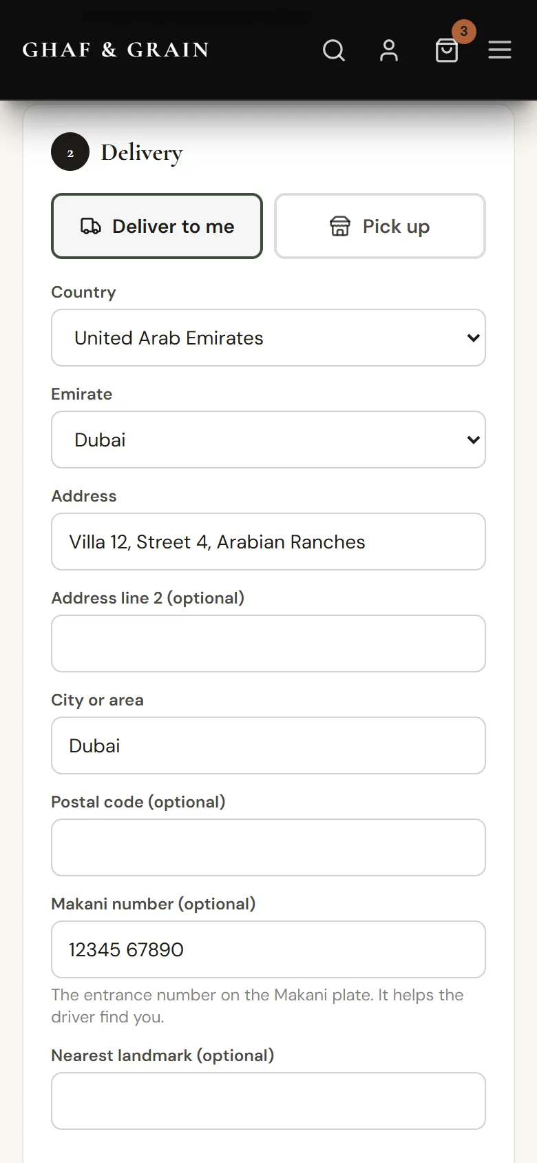 Checkout on a phone: the Delivery step with Deliver to me and Pick up, country, emirate and address.
